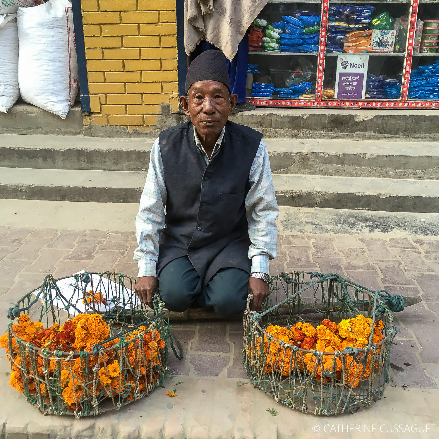 Man with Topi and two baskets of carnations